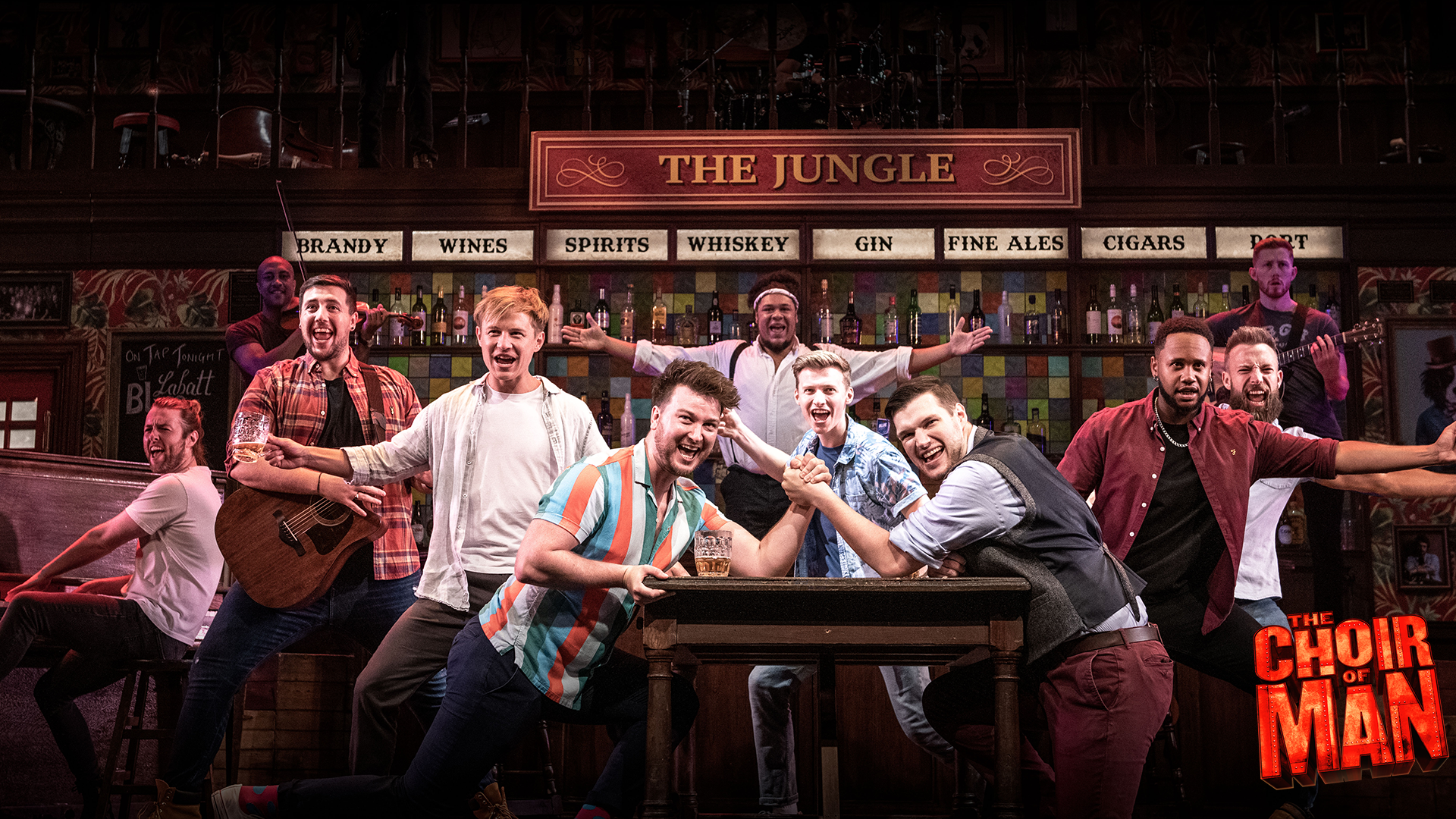 A group of guys in a bar arm wrestling with people holding instruments in the background