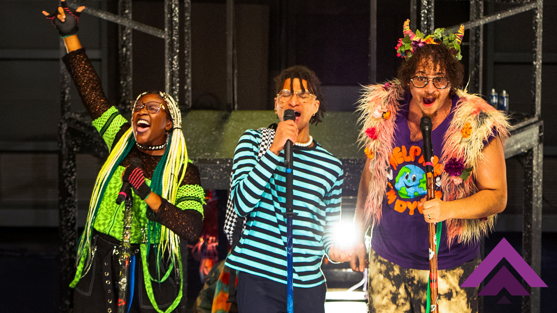 Three kids singing into microphones