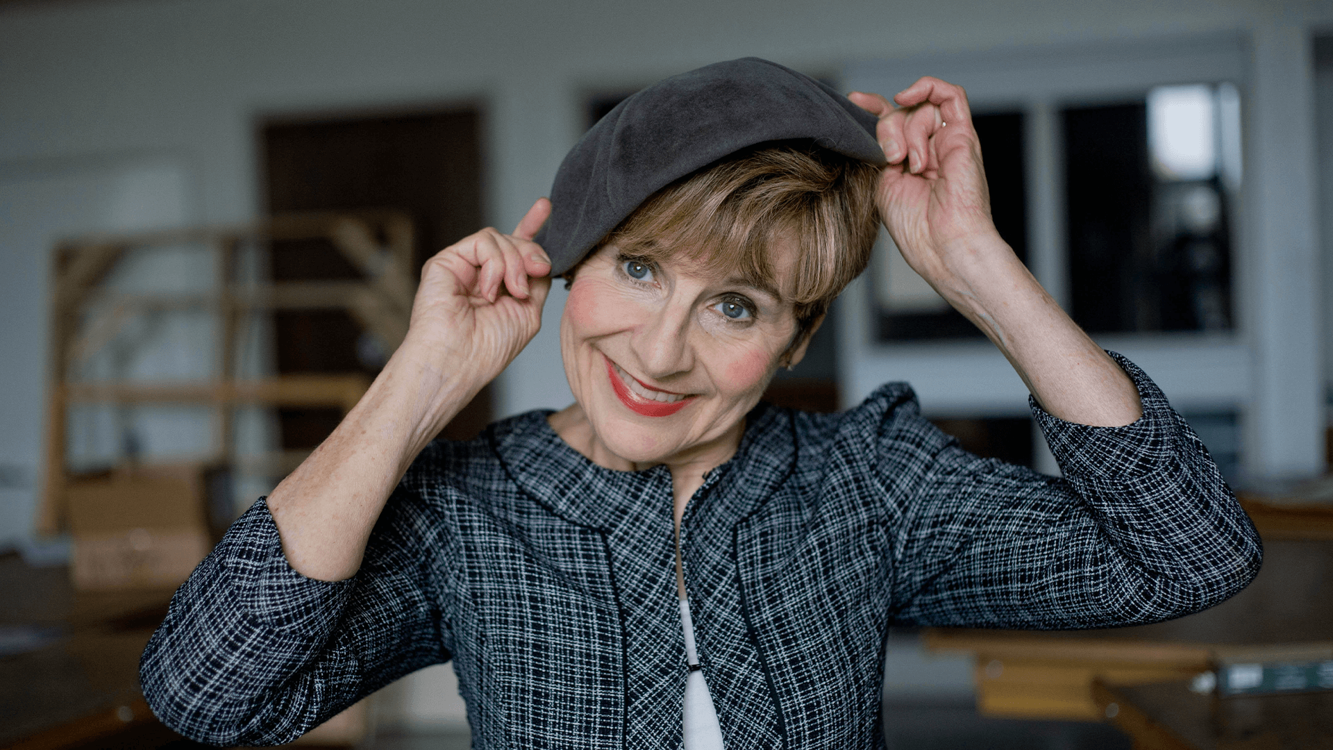 Actress tips her hat to the audience