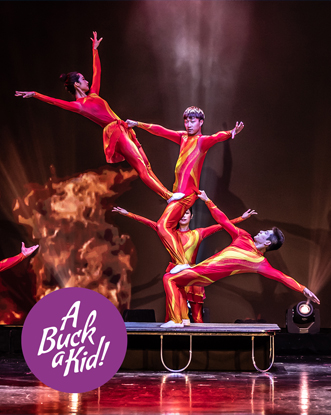 3 acrobatic circus performers wearing red perform a counterbalance trick