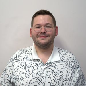 person in white polo shirt and dark hair