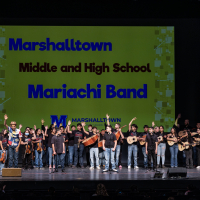 Students on stage holding instruments 123Andres