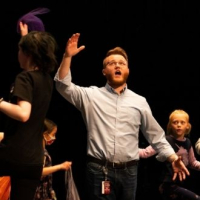 The actor Joseph sings as he's surrounded by youth choir members.