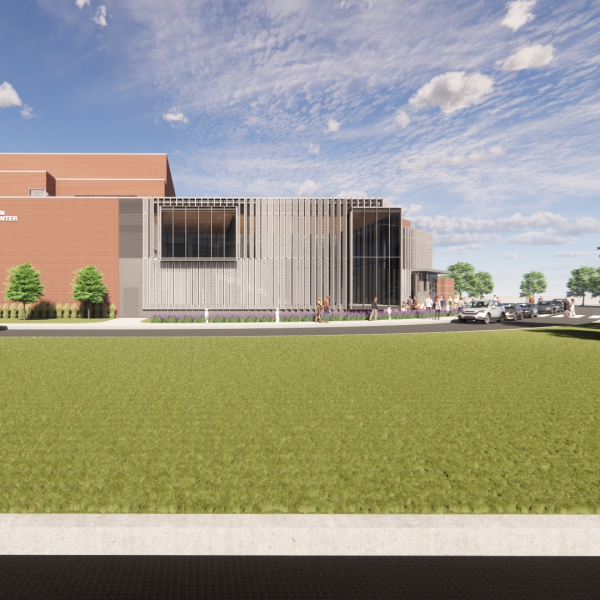 The side of the building with a large glass facade and expanded walkways. 