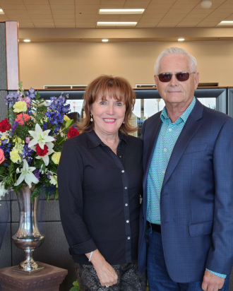 Ardy and Jim Rydell stand next to eachother and smile.
