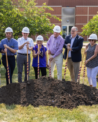 group standing with shovels