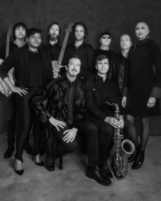 Black and white image of multiple band members