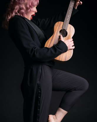 Storm Large holding a guitar
