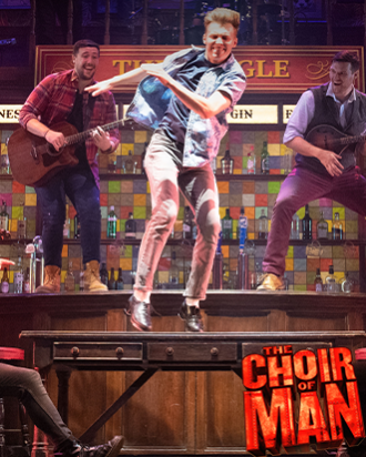 A guy jumping off of the bar top table 